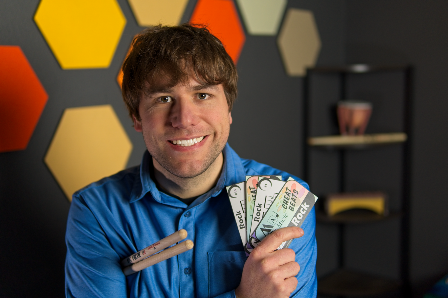 Chase demonstrating the Cheat Beats drum set cards